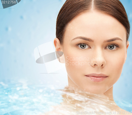 Image of face of beautiful young woman and water splash