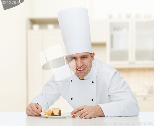 Image of happy male chef cook with dessert