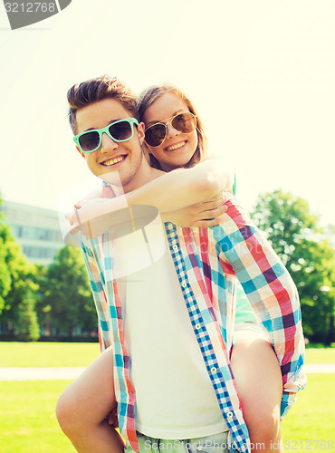 Image of smiling couple having fun in park