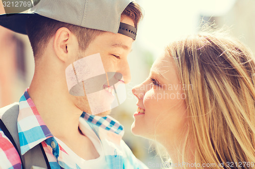 Image of smiling couple with backpack in city