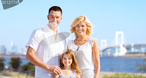 Image of happy family over rainbow bridge background