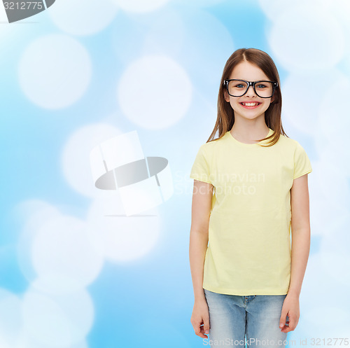 Image of smiling cute little girl in black eyeglasses