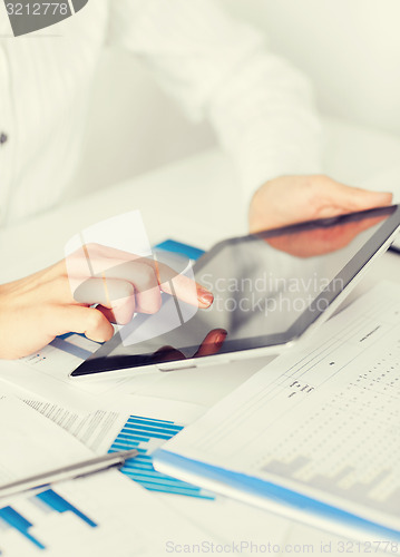 Image of woman with tablet pc and chart papers