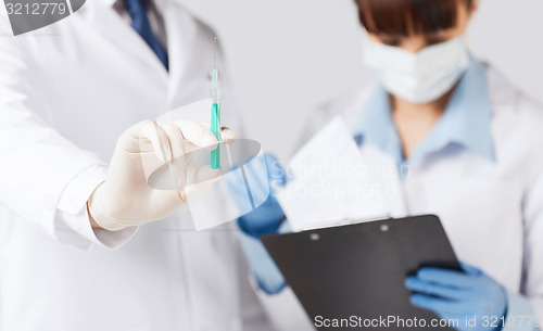 Image of doctors with syringe