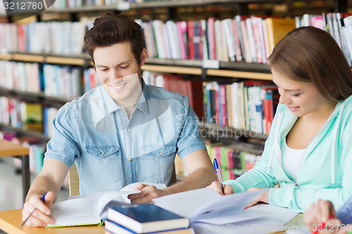 Image of students with books preparing to exam in library