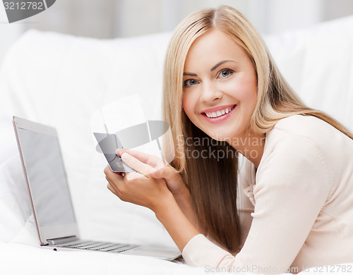 Image of businesswoman with laptop and credit card