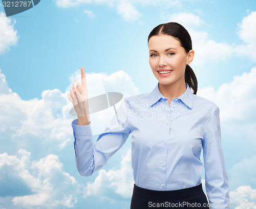 Image of businesswoman touching something imaginary