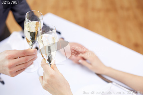 Image of couple with glasses of champagne at restaurant