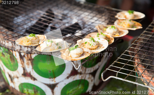 Image of oysters or seafood grill at asian street market