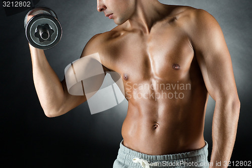 Image of young man with dumbbell