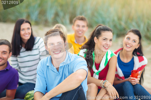 Image of group of happy friends on beach