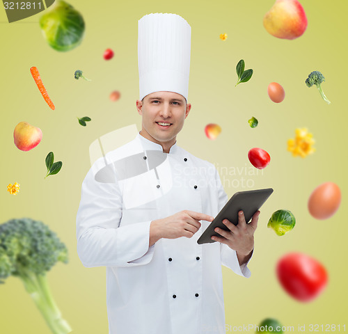 Image of happy male chef cook holding tablet pc