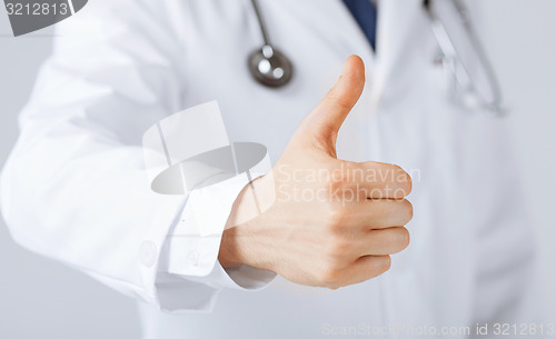 Image of male doctor hand showing thumbs up