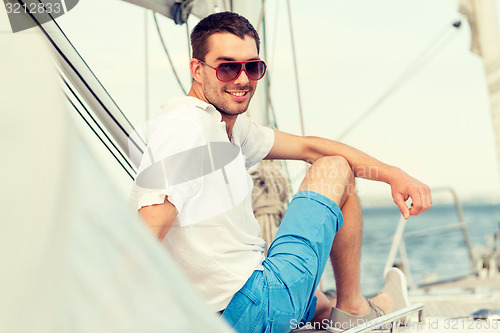 Image of man sitting on yacht deck