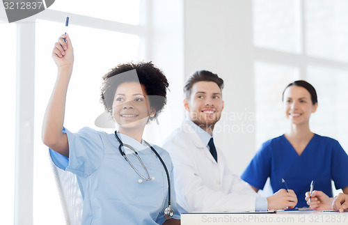 Image of group of happy doctors on conference at hospital