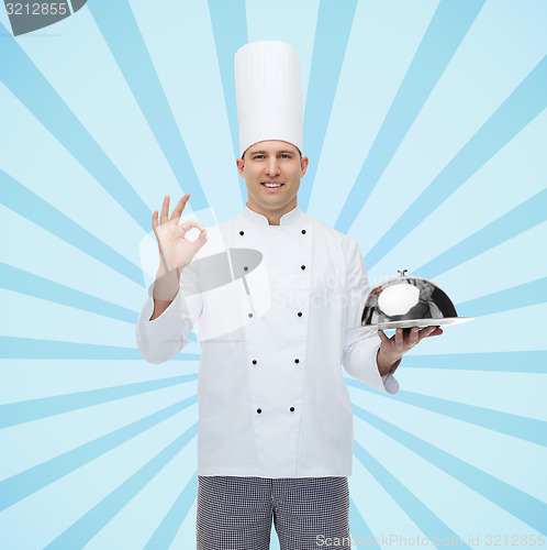 Image of happy male chef cook with cloche showing ok sign