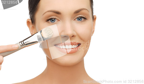 Image of woman applying liquid foundation with brush