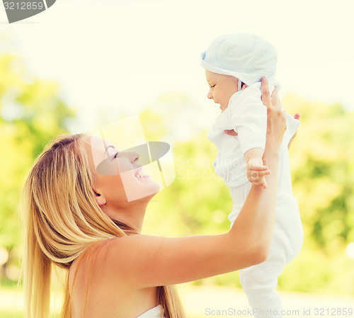 Image of happy mother with little baby in park