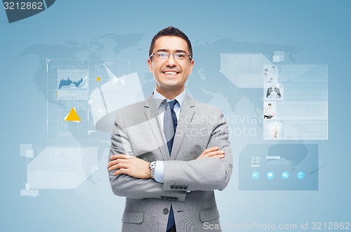 Image of happy businessman with virtual screens