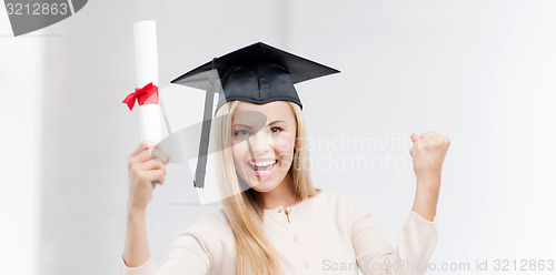 Image of student in graduation cap with certificate