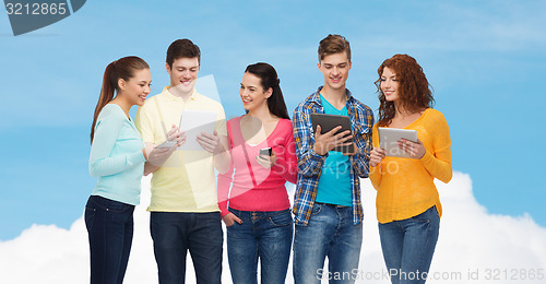 Image of group of teenagers with smartphones and tablet pc