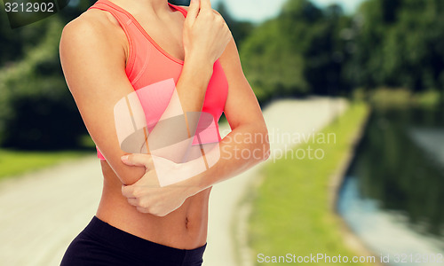 Image of sporty woman with pain in elbow