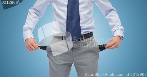 Image of close up of businessman showing empty pockets