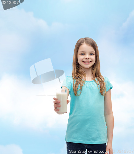Image of smiling little girl giving glass of milk