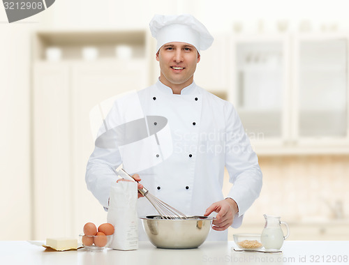 Image of happy male chef cook baking