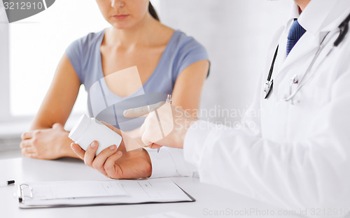 Image of patient and doctor prescribing medication