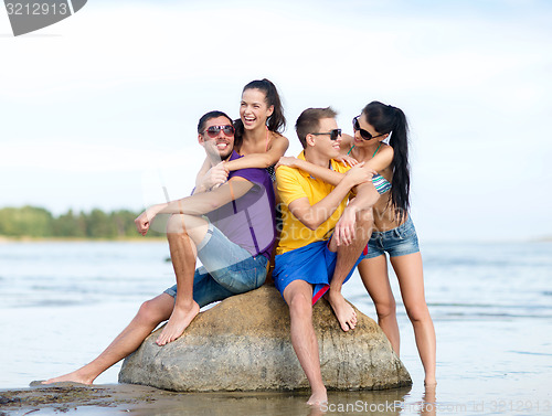 Image of happy friends on summer beach