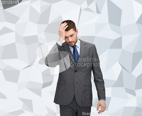 Image of handsome businessman having headache