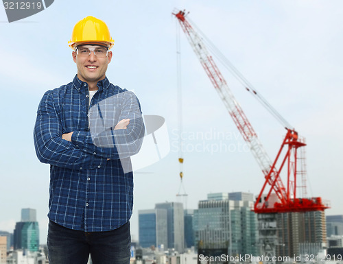 Image of smiling male builder or manual worker in helmet