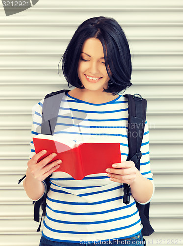 Image of woman with bag and book