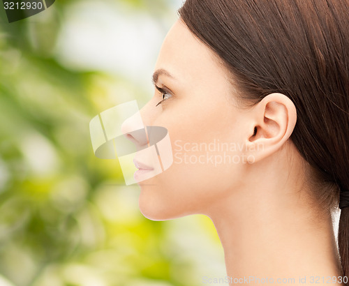 Image of beautiful young woman face over green background