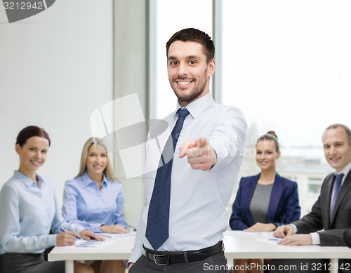 Image of handsome businessman pointing finger at you