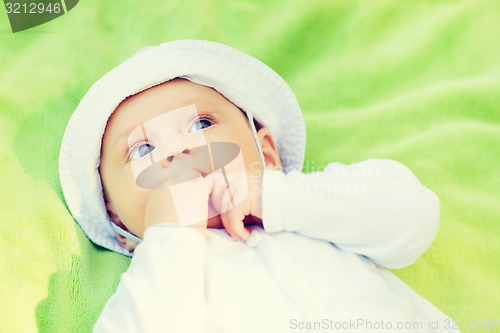 Image of litle baby lying on floor and looking up