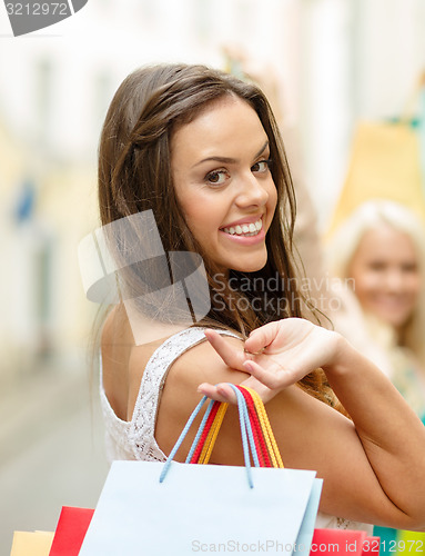 Image of beautiful woman with shopping bags in the ctiy