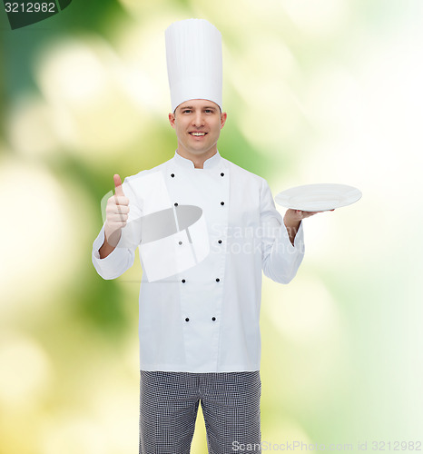 Image of happy male chef cook showing thumbs up and plate