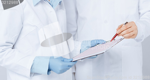 Image of nurse and male doctor holding cardiogram