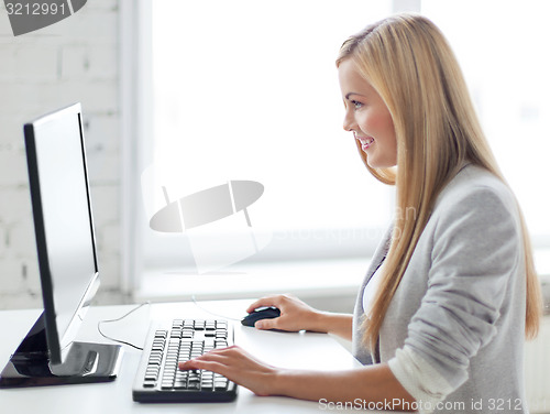 Image of businesswoman with computer in office