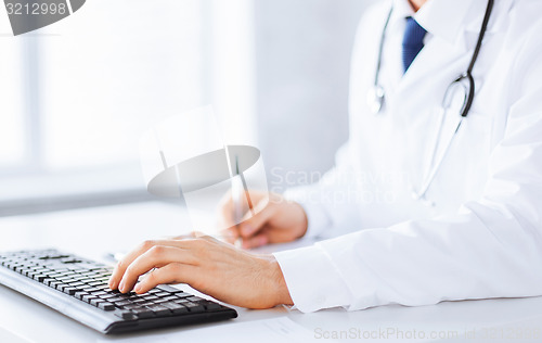 Image of male doctor typing  on the keyboard