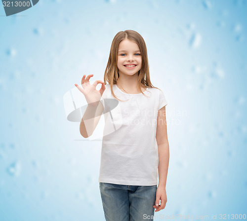 Image of little girl in white t-shirt showing ok gesture