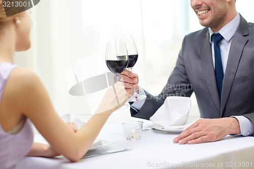 Image of happy couple with glasses of wine at restaurant