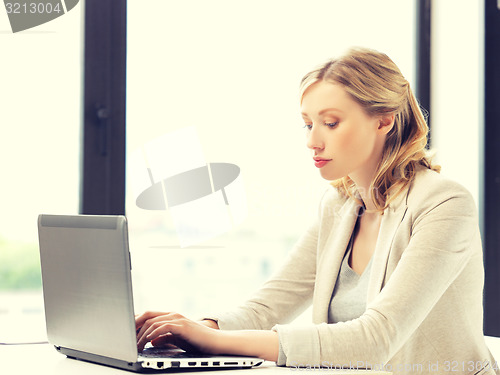 Image of pensive woman with laptop computer