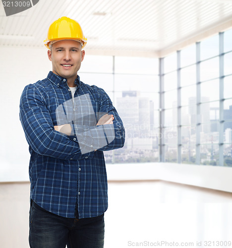 Image of smiling male builder or manual worker in helmet