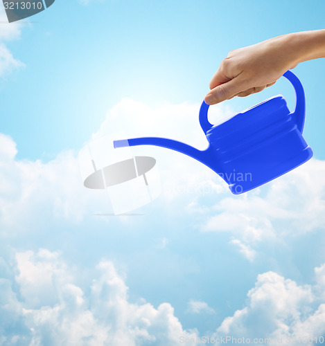 Image of close up of woman hand holding watering can