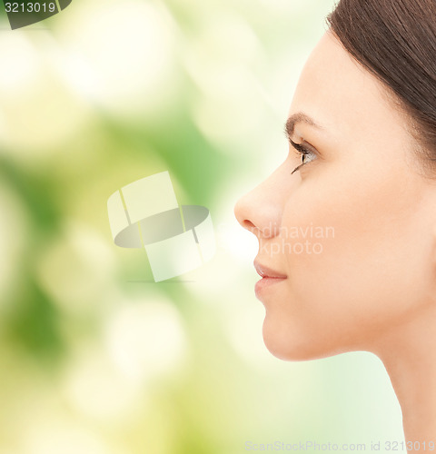 Image of beautiful young woman face over green background