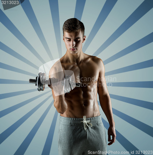 Image of young man with dumbbell flexing biceps