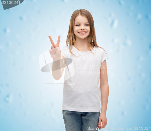 Image of little girl in white t-shirt showing peace gesture